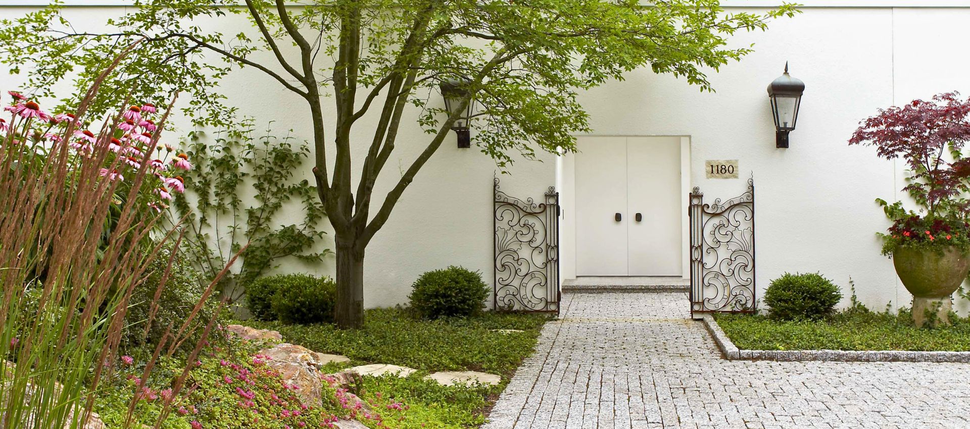 private home with custom made metal swing gates