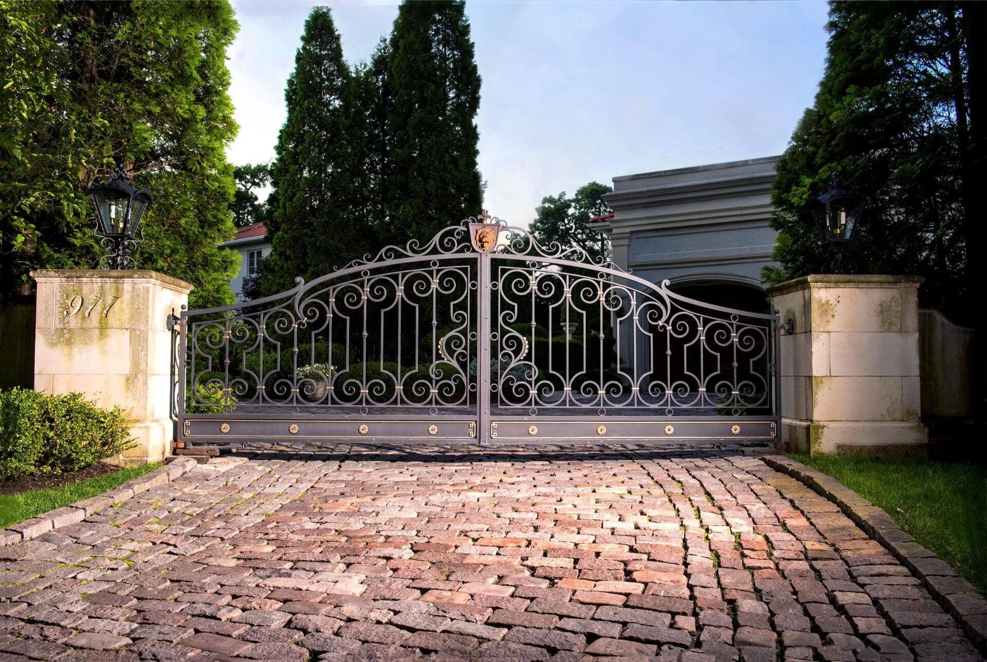 dual metal swing gates with decorative lion emblem